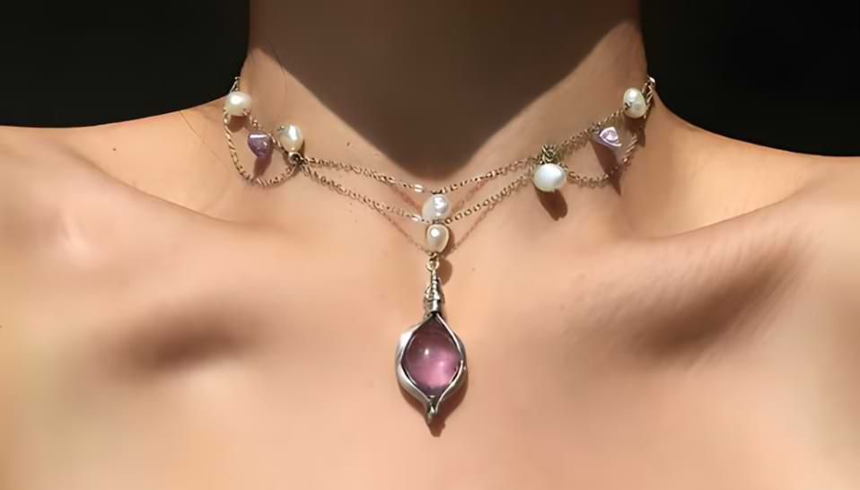 Victorian-style amethyst and pearl choker on model with silver chains and gothic pendant.